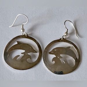 Shiny silver dolphin dangle earrings